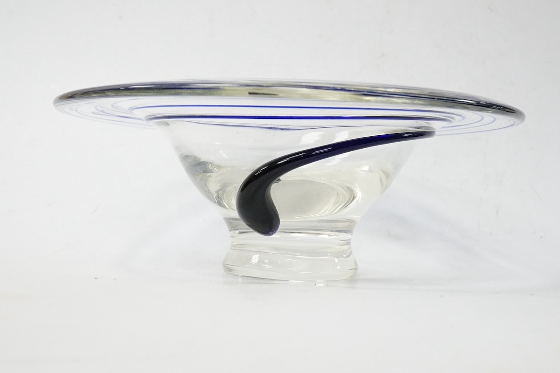 A clear Art glass dish, with blue tube line decoration. 23cm diameter